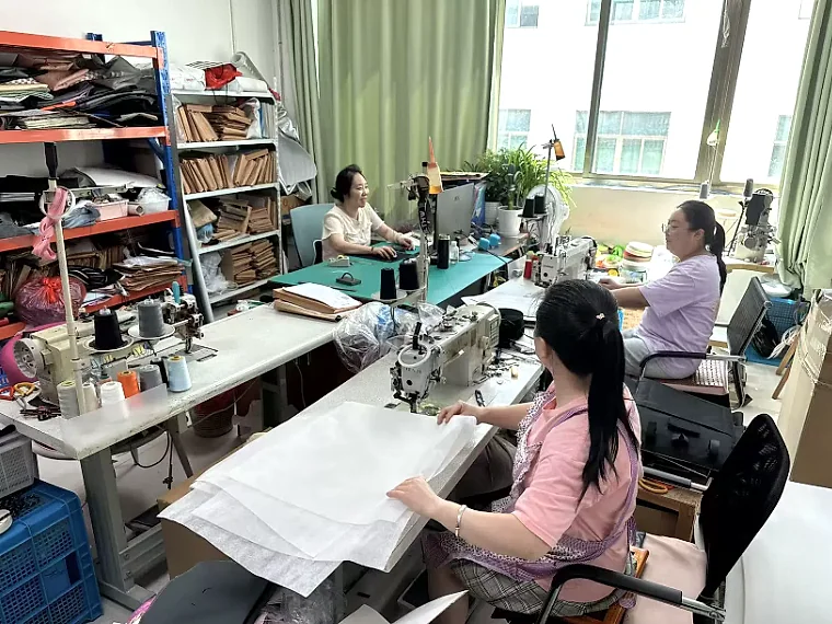 Sample development workspace with staff, sewing machines and paper patterns