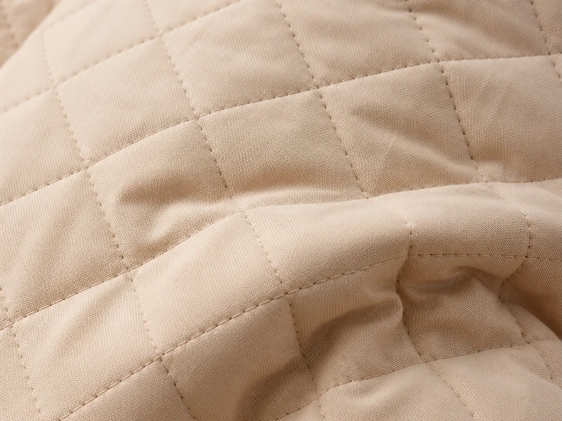 Beige quilted fabric with diamond stitching