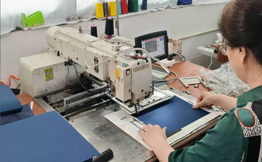 Operator processing bag material components with industrial equipment