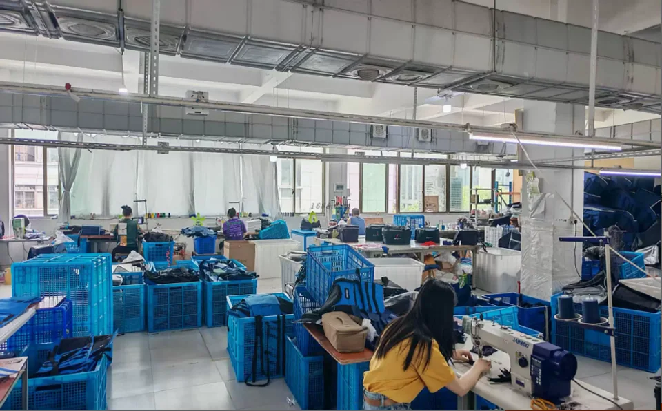 Bag manufacturing workshop with sewing and assembly workstations